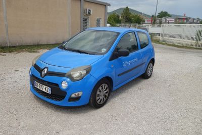 a small blue car parked in a parking lot