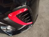 a close up of a car with a red tail light