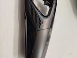 a black cordless vacuum that is on the table