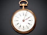 a gold pocket watch with roman numerals on the face