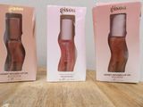 two boxes of lip glosses sitting on a wooden table next to each other
