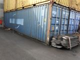 a blue container sitting on top of a pile of metal