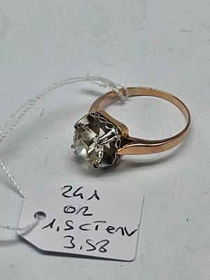 a gold ring with a diamond on it and a price tag attached to it
