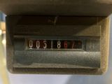 a close up of a clock on the side of a bus