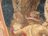 a painting on the wall of a building with a painting of a man laying on the ground