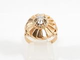 a close up of a gold ring with a diamond in the center