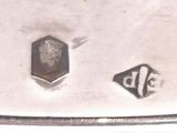 a close up of a silver plate with a picture of a man on it