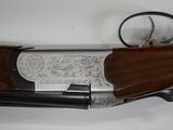a close up of a shotgun with a wooden handle on a white surface