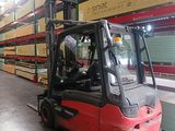 a red forklift truck parked in a warehouse