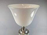 a white vase sitting on top of a table