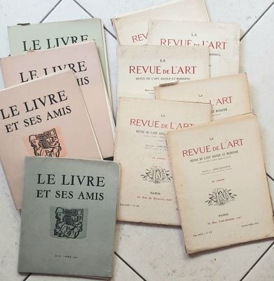 several books on a tile floor with a white tile floor in the background