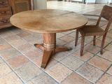 a wooden table and two chairs in a room