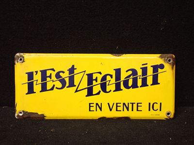 un panneau jaune sur lequel on peut lire « est éclair en vente icl »