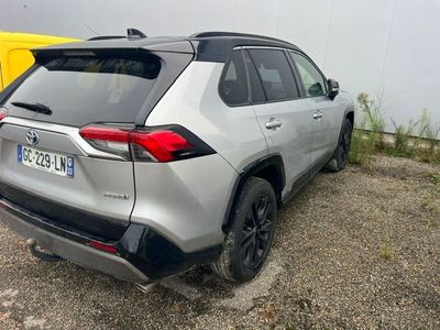 the rear end of a silver toyota rav parked in a parking lot