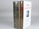 two books sitting on top of each other on a white surface