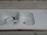 a white sink that is sitting next to a cardboard box