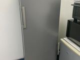 a silver refrigerator next to a black and white microwave