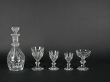 a group of glass wine glasses and a decanter on a black background