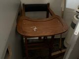 a small table and chair in the corner of a bathroom
