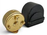 an image of a black and gold clock sitting next to each other