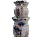 a white vase with a blue and gold design on it