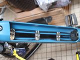 a blue scooter that is sitting on the floor