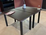 a table that has a cup on it in the middle of the room