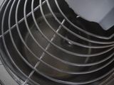 a close up of a metal fan on a tiled floor