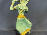 an image of a statue of a woman playing a flute