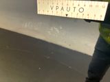 a person holding a ruler that is on a wall