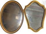 two mirrors that are next to each other on the wall
