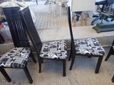 four chairs that have been painted black and white