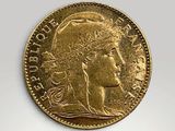 a close up of a gold coin with a woman ' s face on it