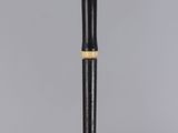 the pen is sitting on a clear surface with a black and gold trim