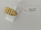 a close up of a gold ring on a white surface