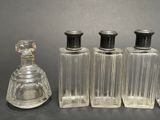 three clear glass bottles sitting next to each other on top of a table