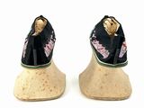 a pair of shoes that are sitting on top of a wooden block
