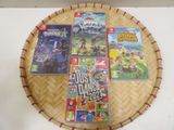 several video games on a bamboo tray on a white table