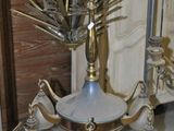 a silver and gold chandelier with glass lamps on it