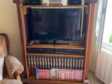 a television on a stand in the corner of a living room