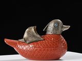 a red bird sitting on top of a white table