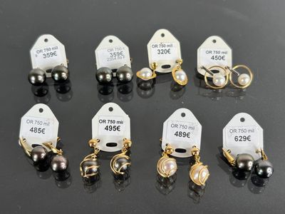 a lot of different types of earrings on the table