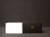 a black and white box and a white box on a table