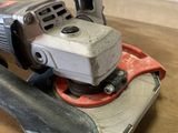 someone is using a sander on a wooden table to clean the surface