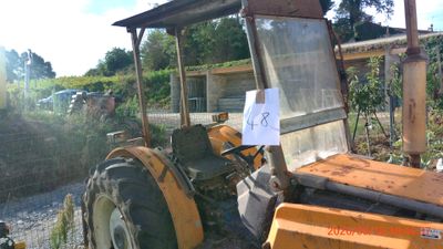 a tractor that is parked in the dirt