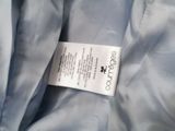 an image of a label is attached to a blue jacket