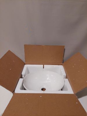 a white bowl inside of a cardboard box on a table