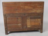 an old wooden cabinet with two doors and a drawer on top