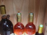 three bottles of wine sitting on a shelf next to each other