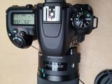 a camera with a lens attached to it on a table
